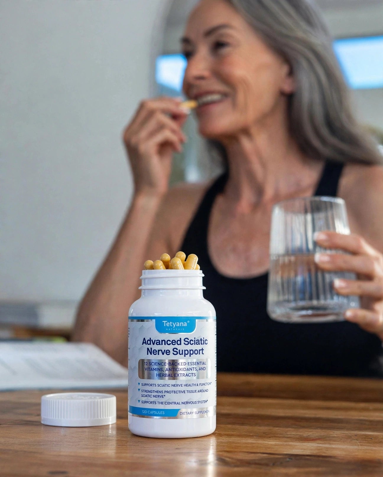 Taking the evening capsule with a glass of water — Advanced Sciatic Nerve Support on the kitchen table